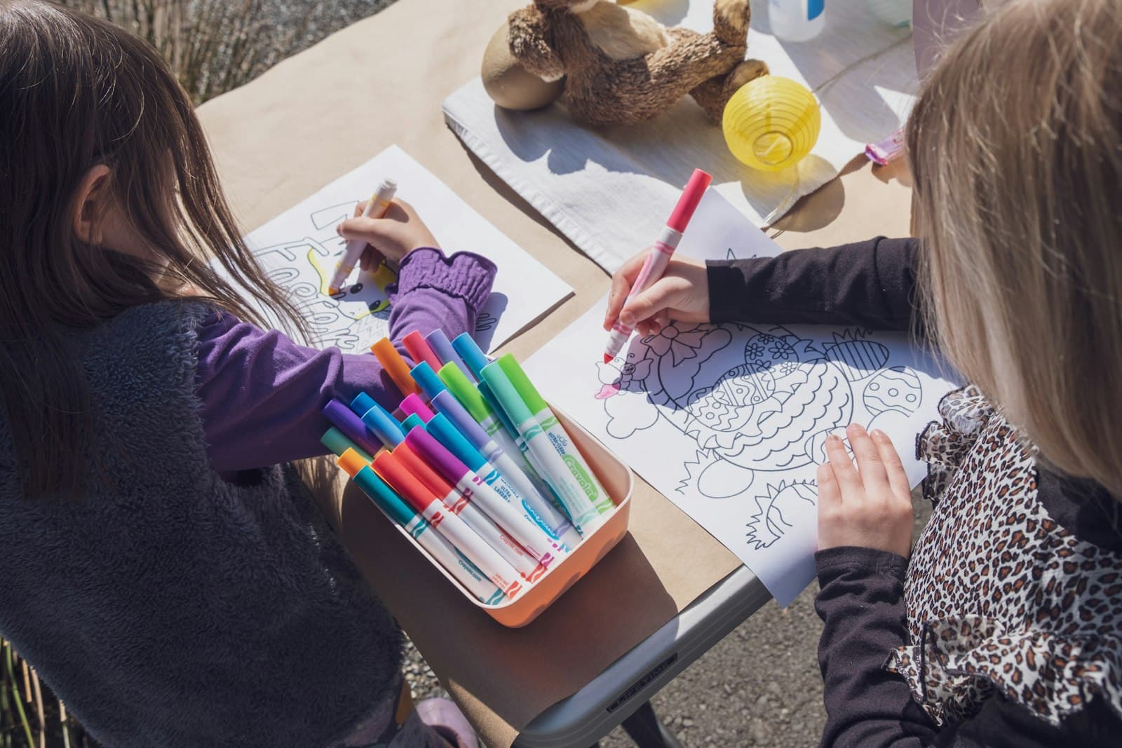 Two girls coloring with markers